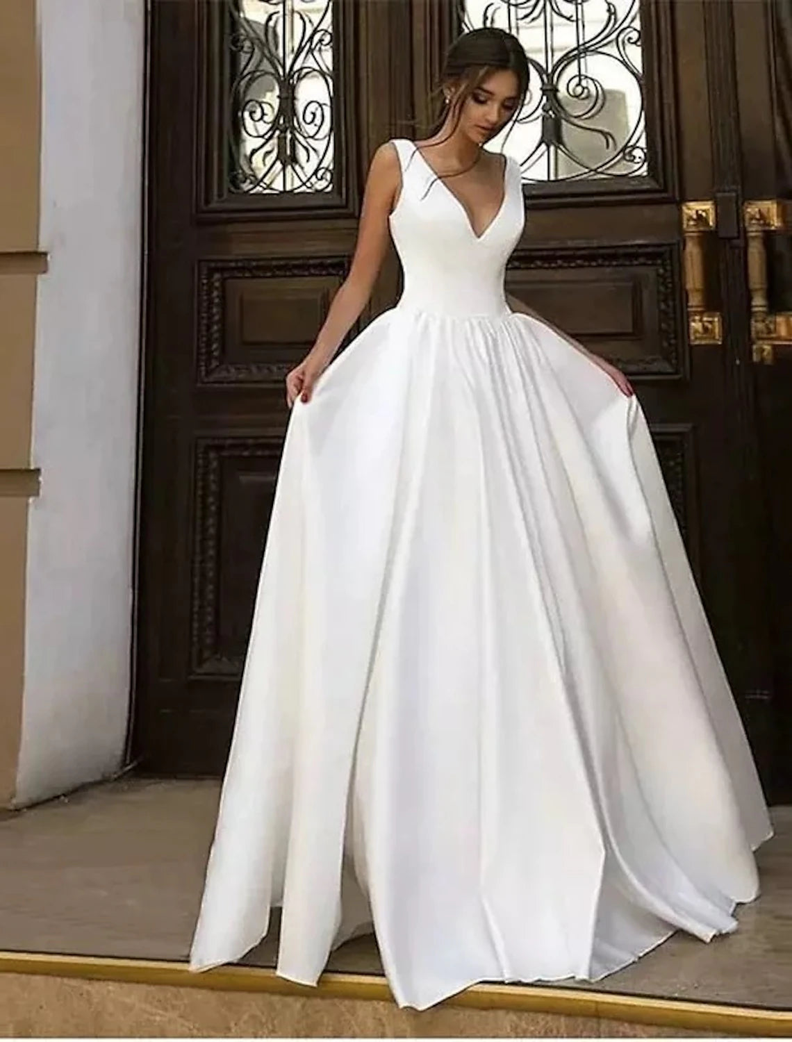 Elegant A-line V-neck sleeveless satin wedding dress with delicate pleats.