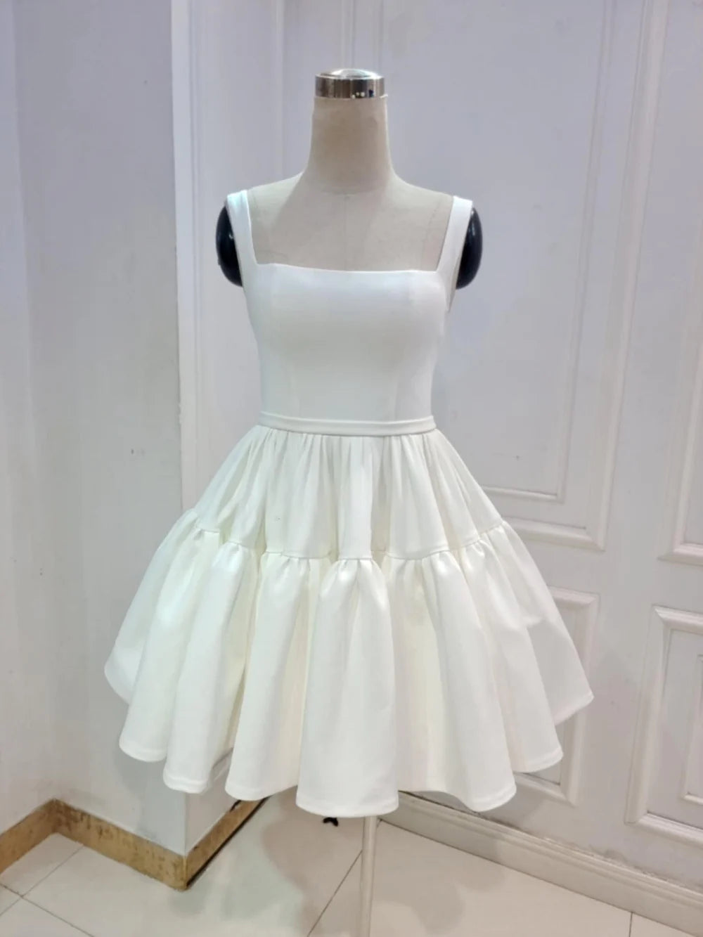 Elegant A-line V-neck sleeveless satin wedding dress with pleats.