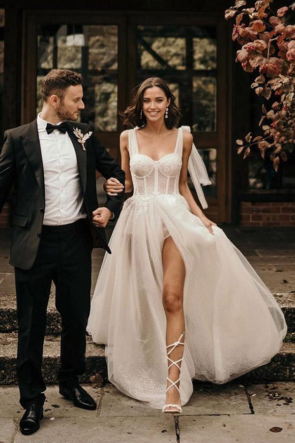 Elegant ivory A-line wedding dress with sequins and a sweep train.