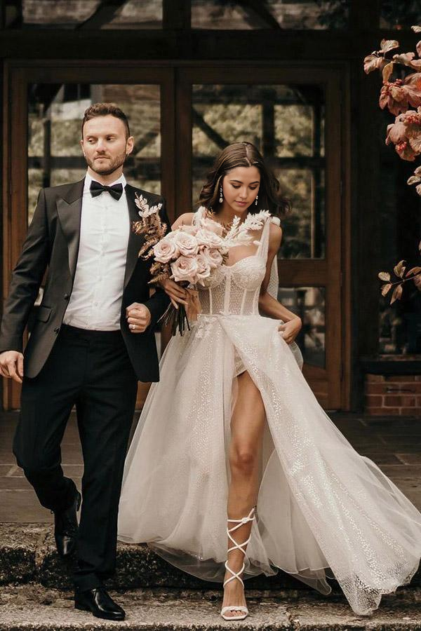 Side view of a sleeveless ivory A-line bridal gown.