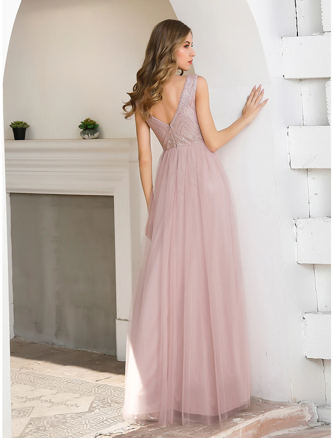 Close-up of the V-neckline and sequin embellishments on the gown.