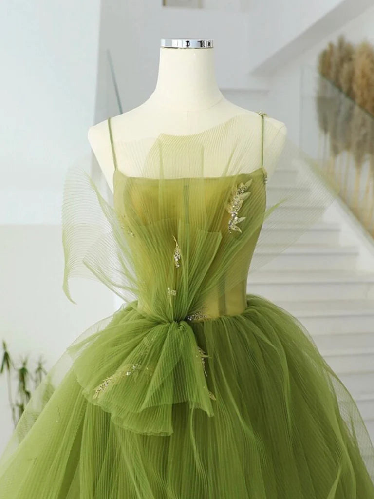 Back view of a green A-line tulle prom dress.