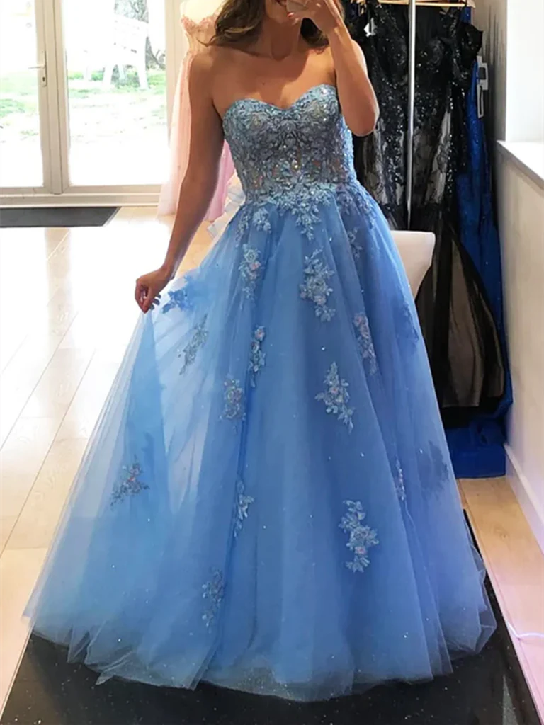 Woman wearing an elegant A-line V-neck prom dress with a lace bodice and flowing tulle skirt.