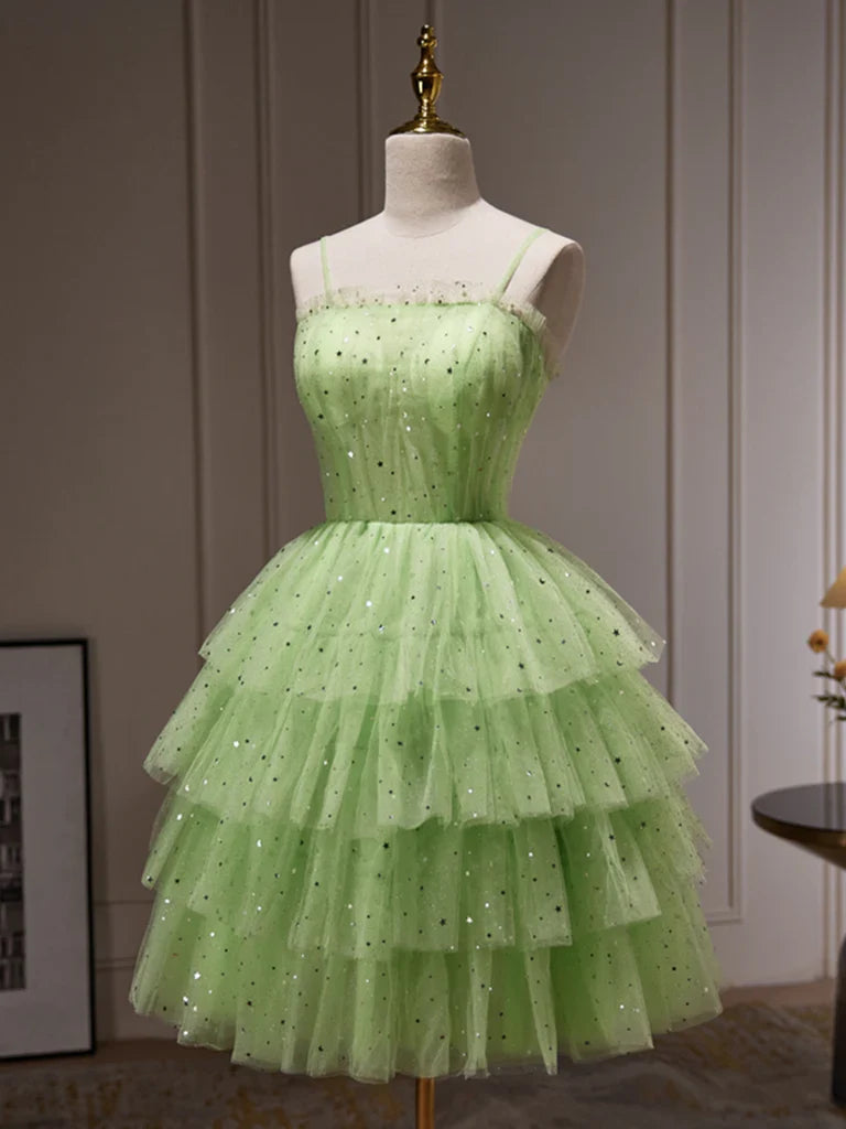 Side view of a woman in a shimmering tulle sequin graduation dress.