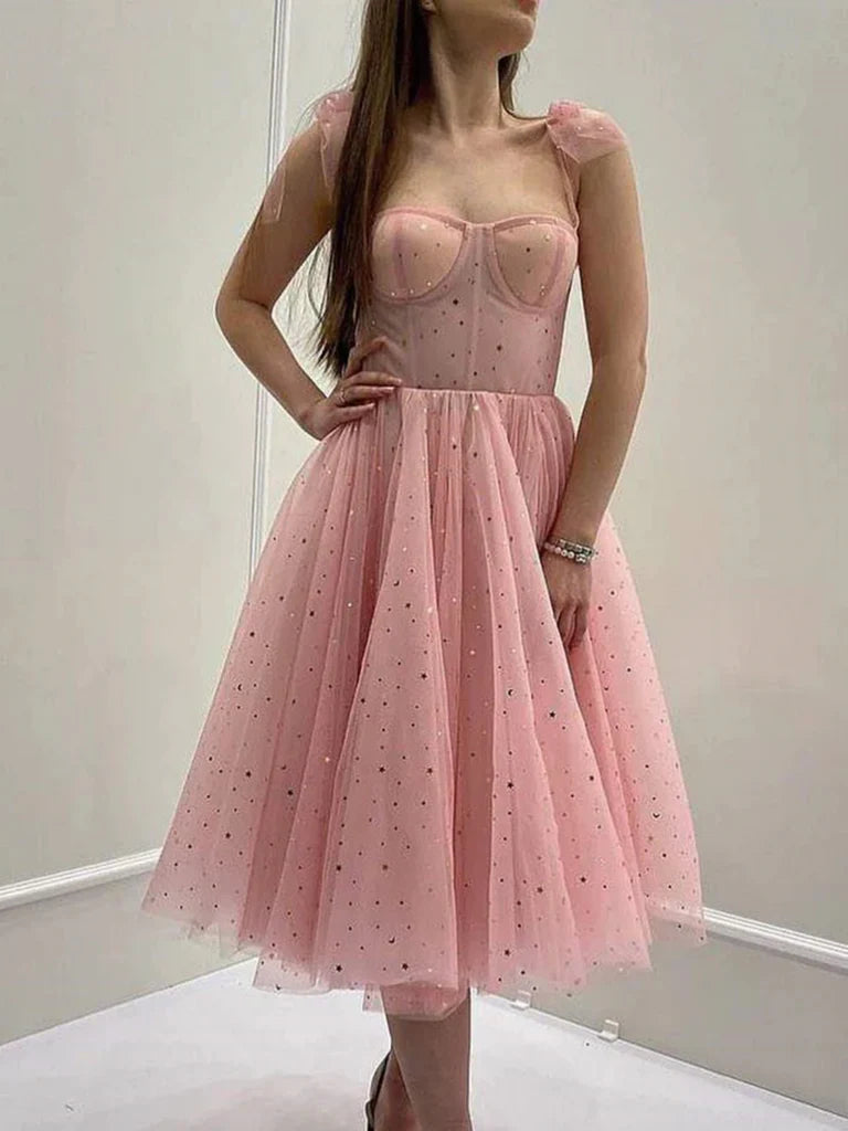 Woman wearing an elegant A-line V-neck sleeveless tea-length tulle prom dress.