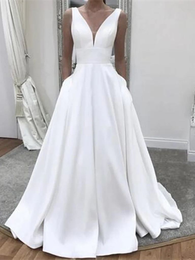 Woman wearing an elegant A-line V-neck sleeveless wedding dress.