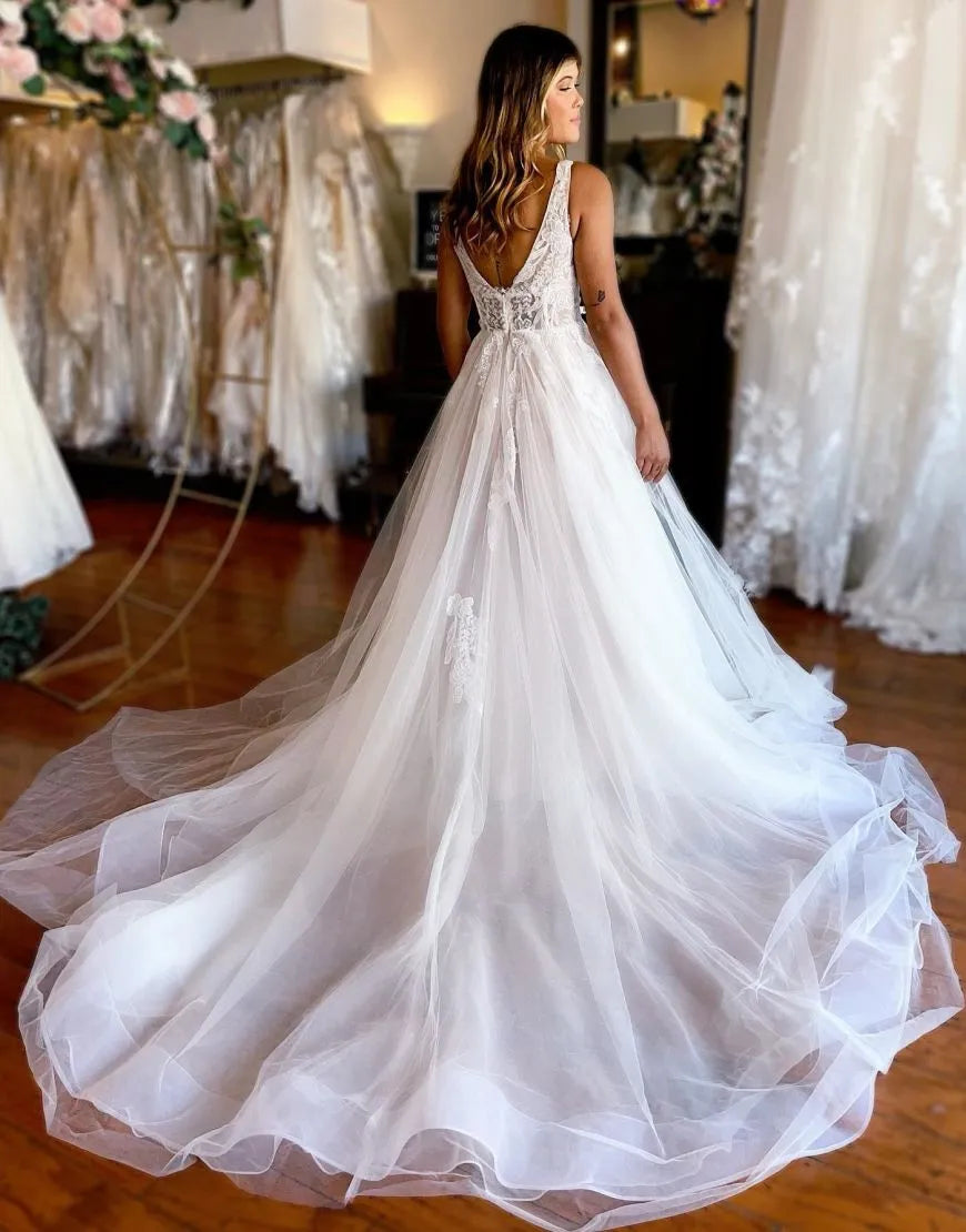 Front view of the A-line V-neck wedding gown with delicate appliques.