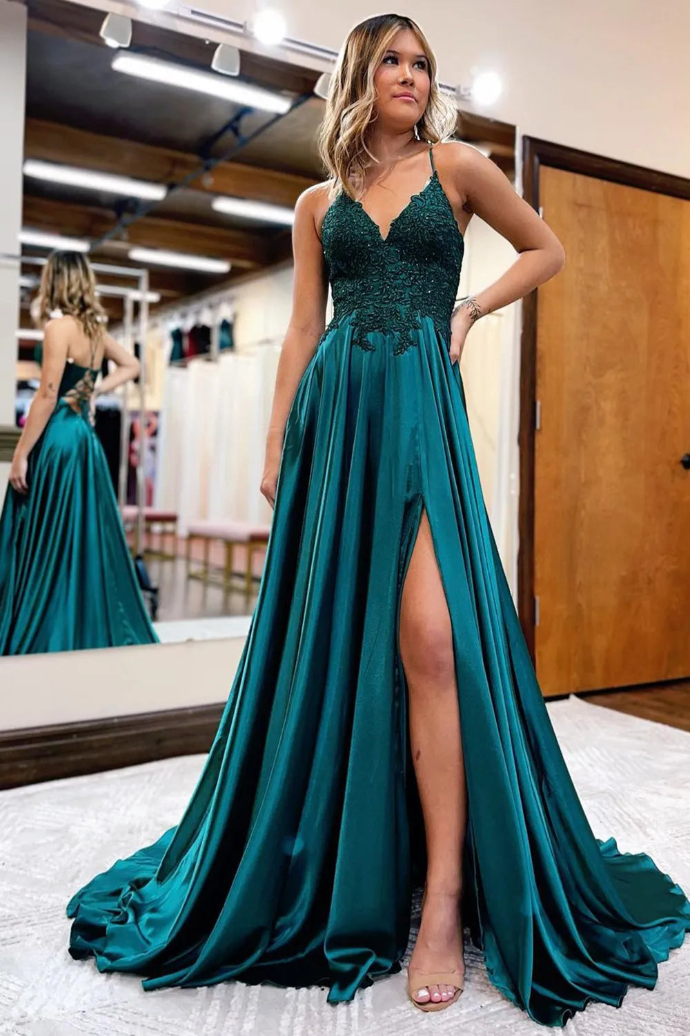 Elegant A-line prom dress with spaghetti straps and intricate appliques.