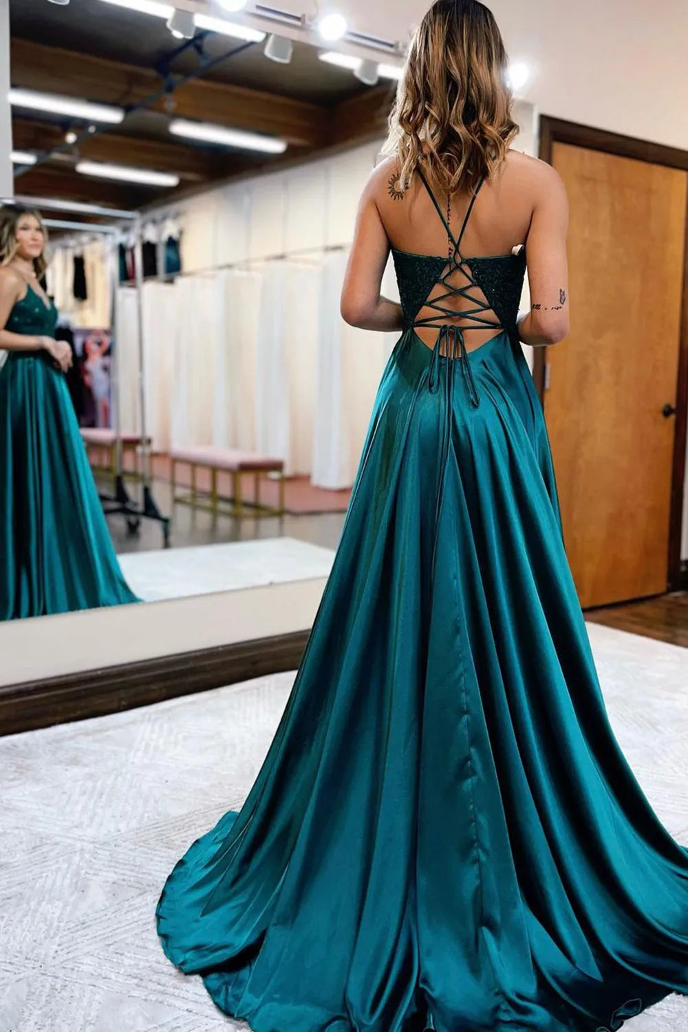 Close-up of the V-neck bodice with delicate appliques on the prom dress.
