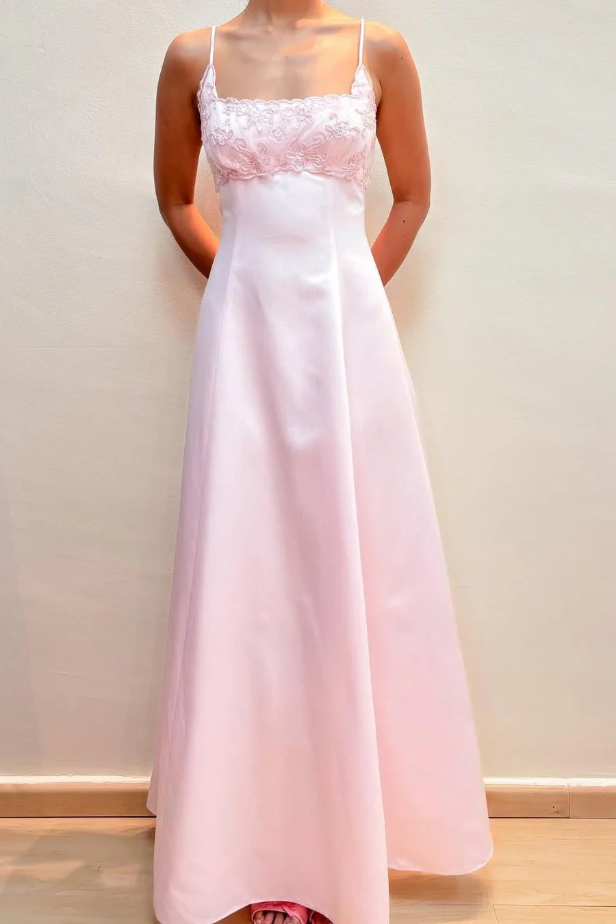 Pink satin A-line prom dress with spaghetti straps and appliques.