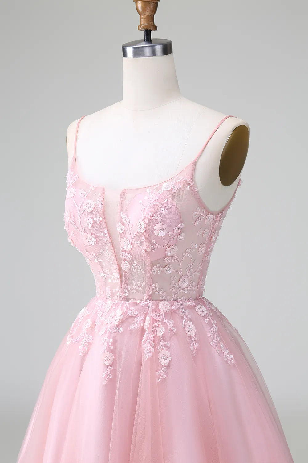 Model posing gracefully in the elegant short homecoming dress.