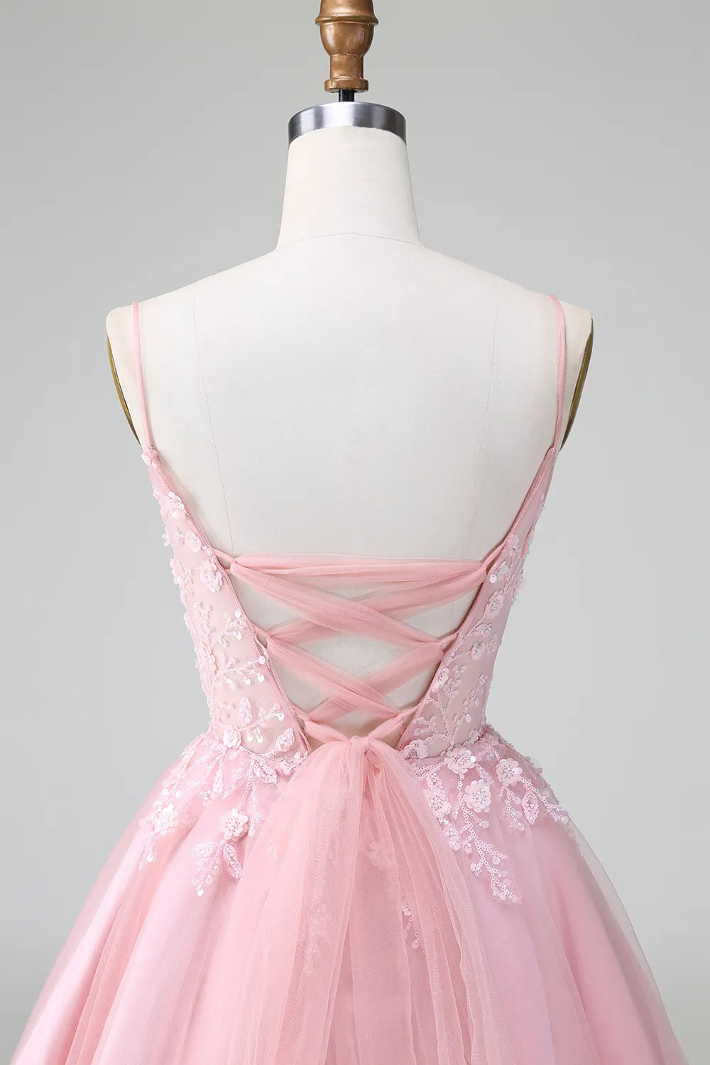 Detail of the spaghetti straps and V-neckline on the tulle dress.