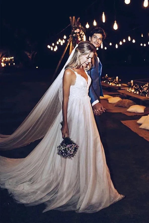 Back view of an A-line beach wedding dress featuring spaghetti straps and an open back.