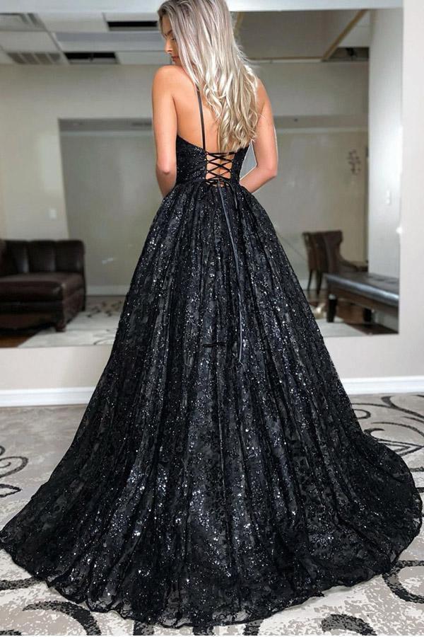 Model wearing a black sequin A-line evening gown with V-neck and spaghetti straps.