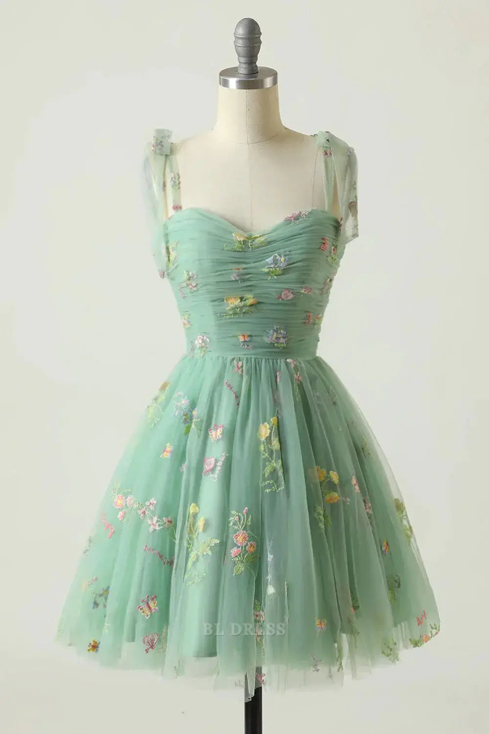 Champagne A-line short dress with spaghetti straps, front view.