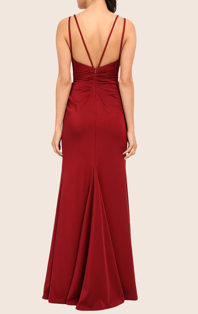 Back view of a woman in a flowing A-line chiffon evening gown.