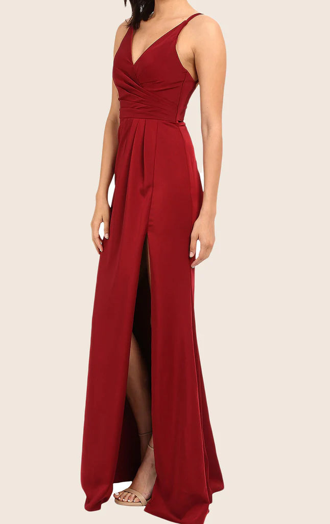 Side profile of a woman showcasing the V-neck and spaghetti straps of a formal dress.