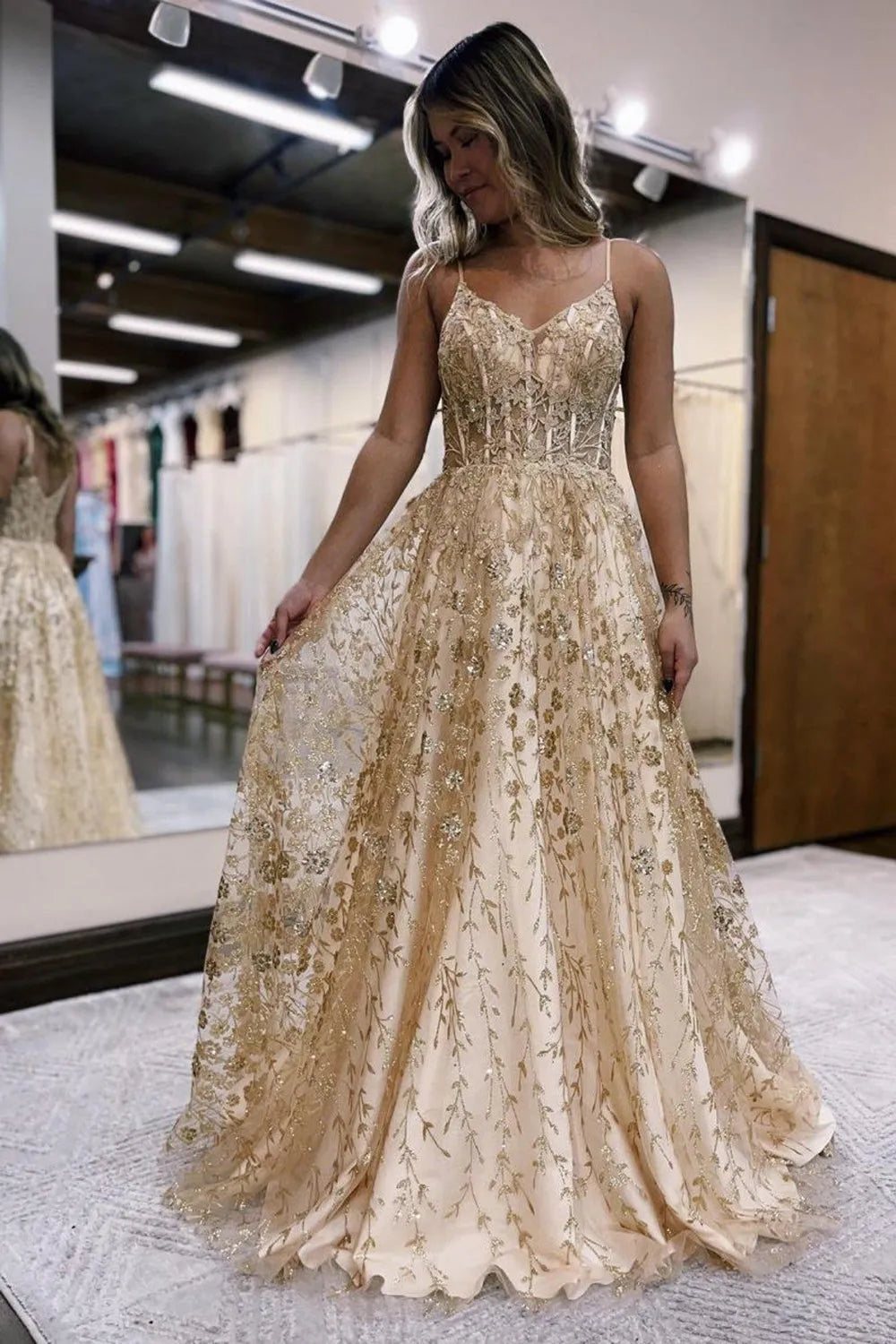 Prom dress detail showcasing spaghetti straps and V-neck.