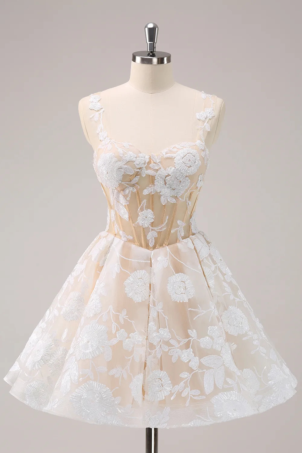 White A-line short homecoming dress with spaghetti straps and appliques.