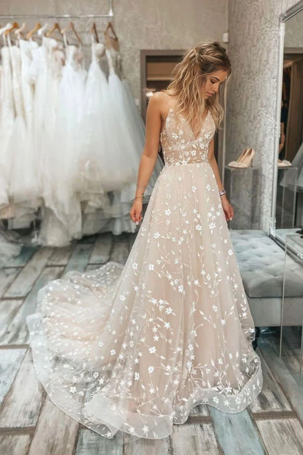 Elegant A-line wedding dress with spaghetti straps and V-neckline.