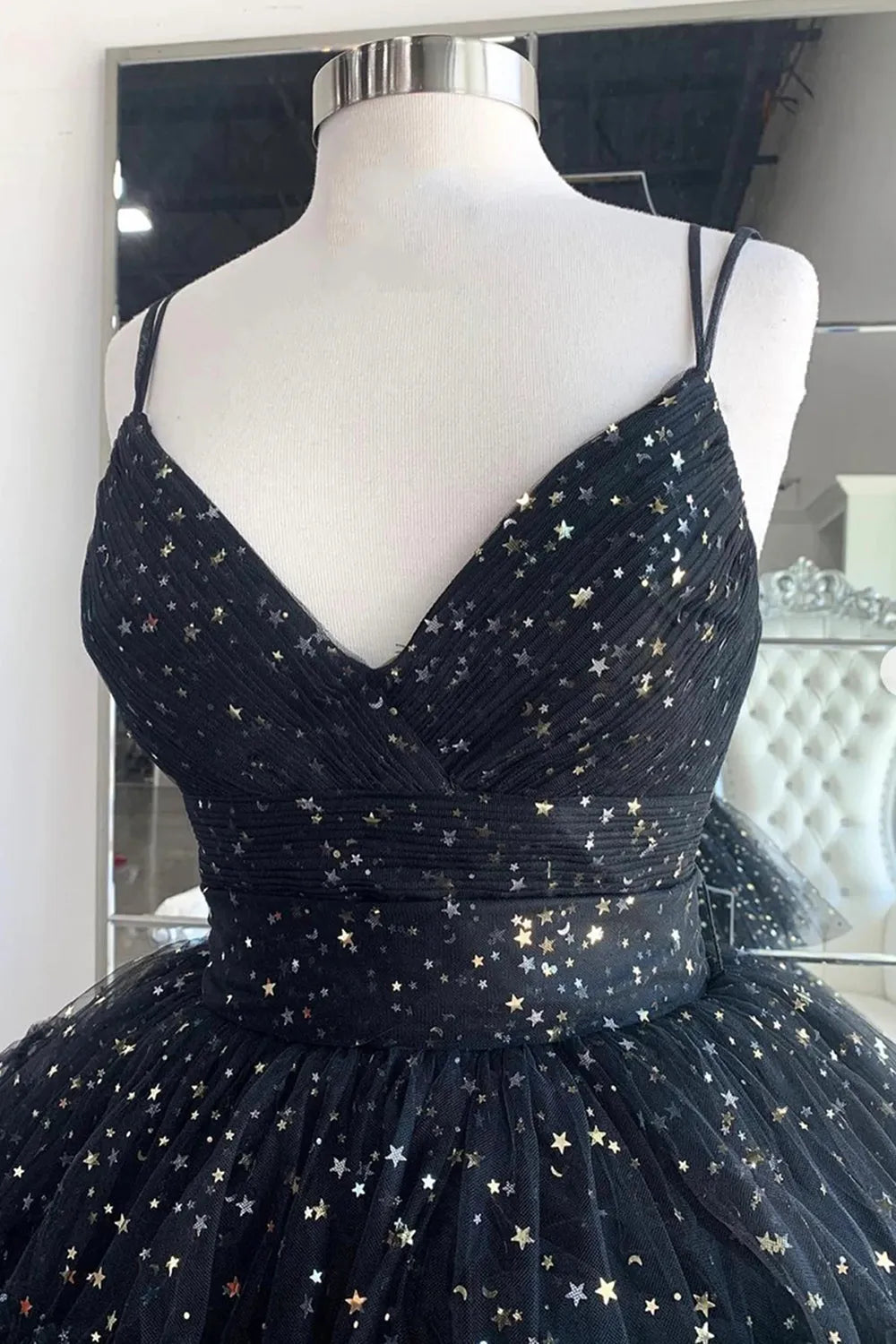 Back view of the high-low ruffle prom dress, showcasing the V-neck and spaghetti straps.