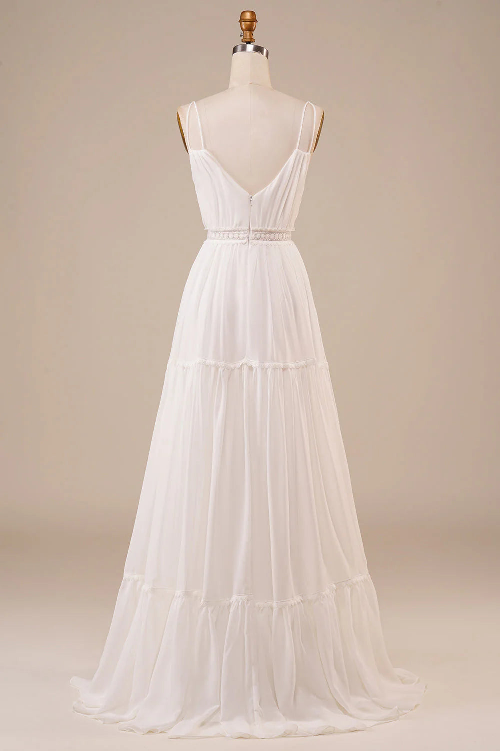 Back view of an A-line ivory wedding gown with flowing skirt.
