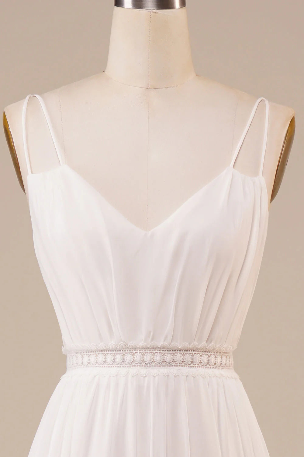 Close-up of the bodice and V-neckline of an ivory A-line wedding dress.