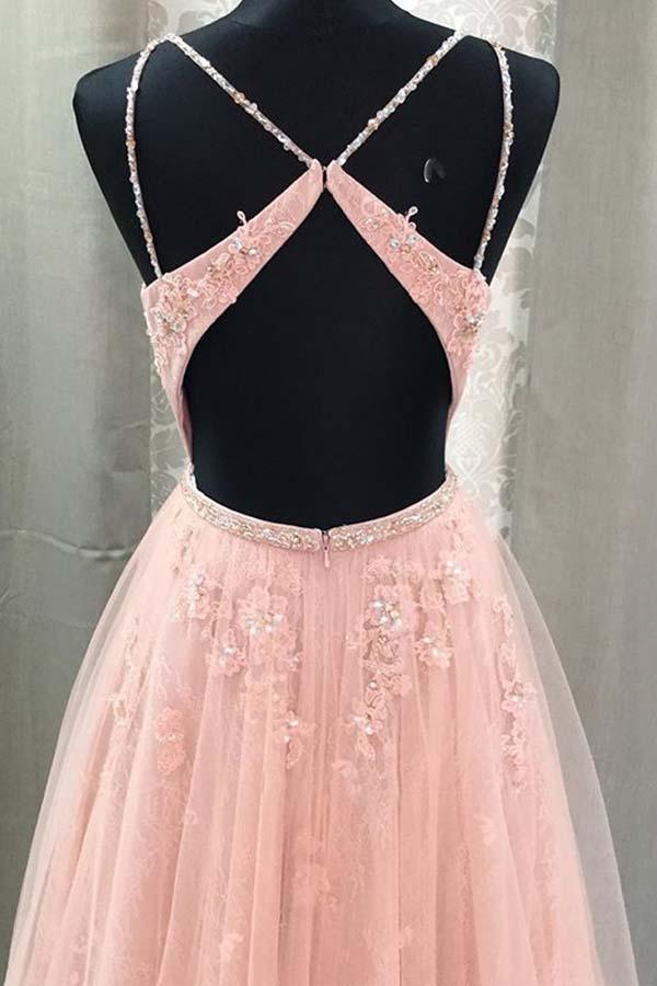 Back view of a long lace A-line prom dress with delicate spaghetti straps.
