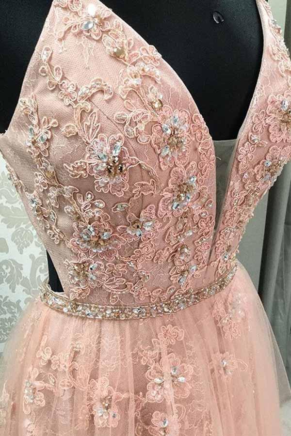 Side view of a V-neck A-line lace gown, highlighting the flowing skirt.