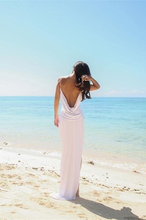 Back view of the white A-line wedding dress, highlighting the open back and side slit.