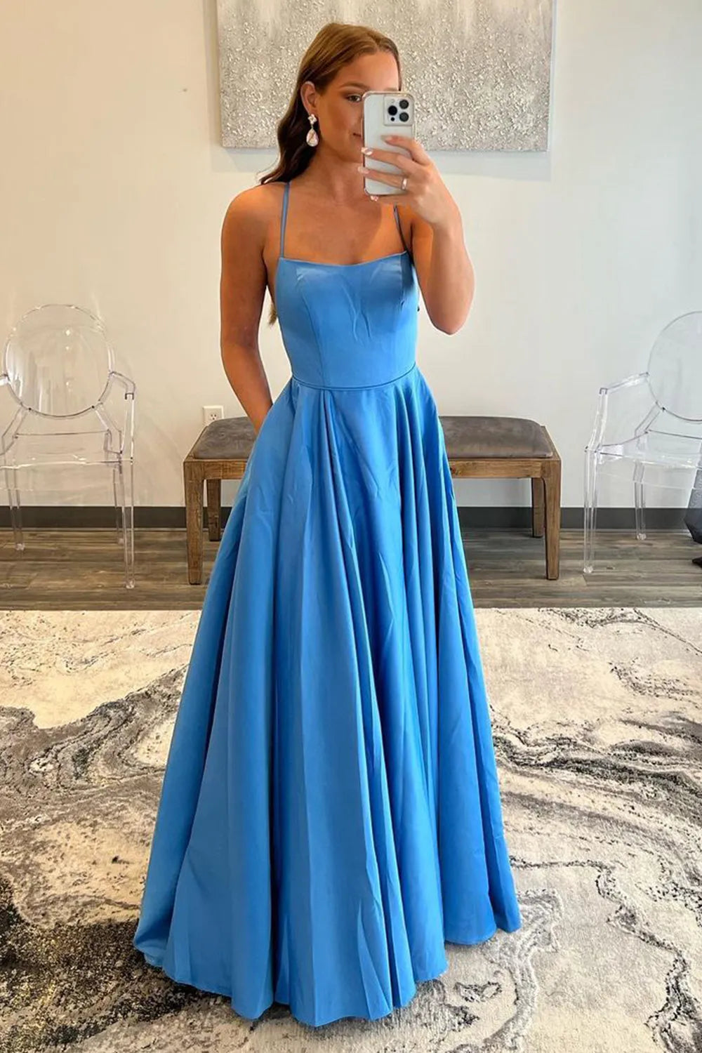 Elegant A-line prom dress with spaghetti straps and V-neckline, featuring pockets.
