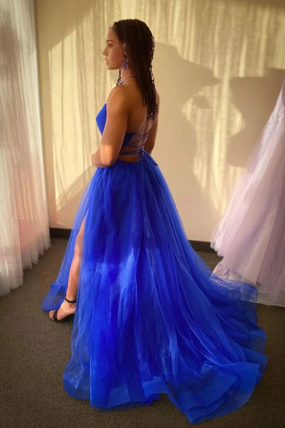 Back view of a long royal blue evening gown, A-line silhouette.