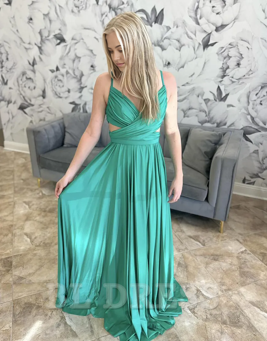 Close-up of the ruched V-neck bodice and spaghetti straps on the green formal gown.