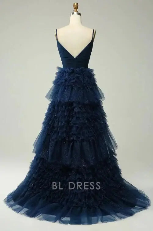 Back view of navy A-line prom dress with flowing ruffles.
