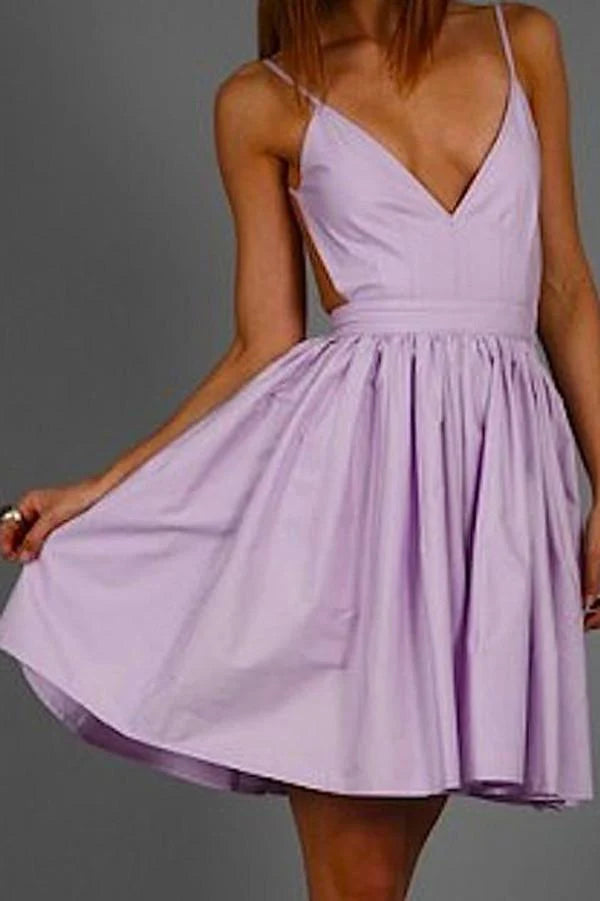 Woman wearing a short A-line V-neck dress with spaghetti straps.