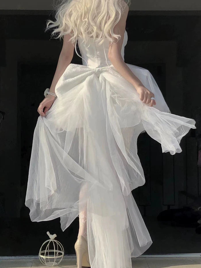 Back view of the white A-line spaghetti strap dress.