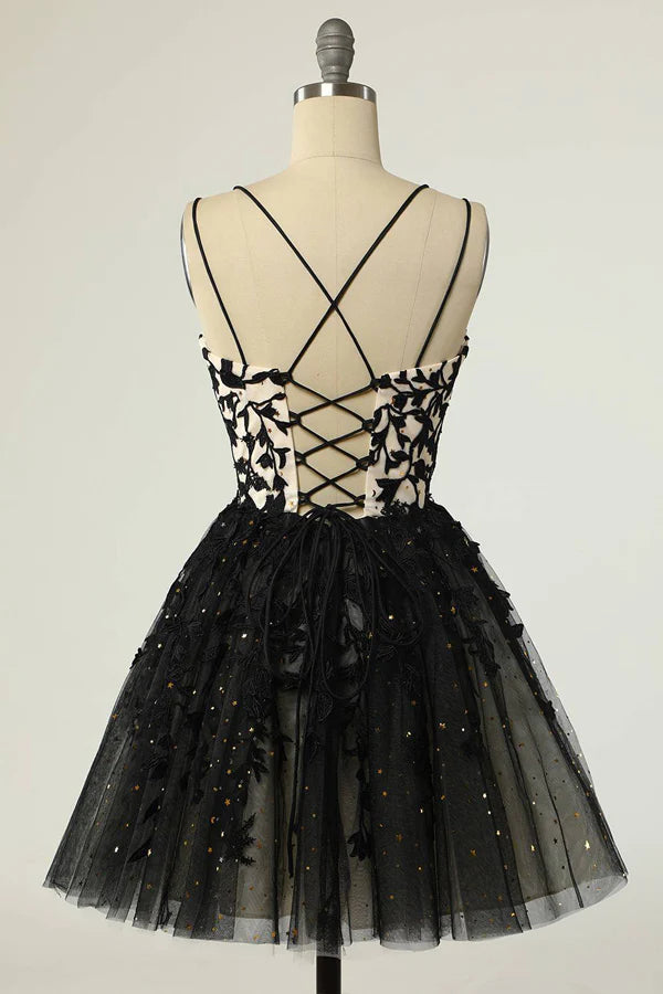 Black sequin A-line homecoming dress with appliques and V-neck straps, side view.