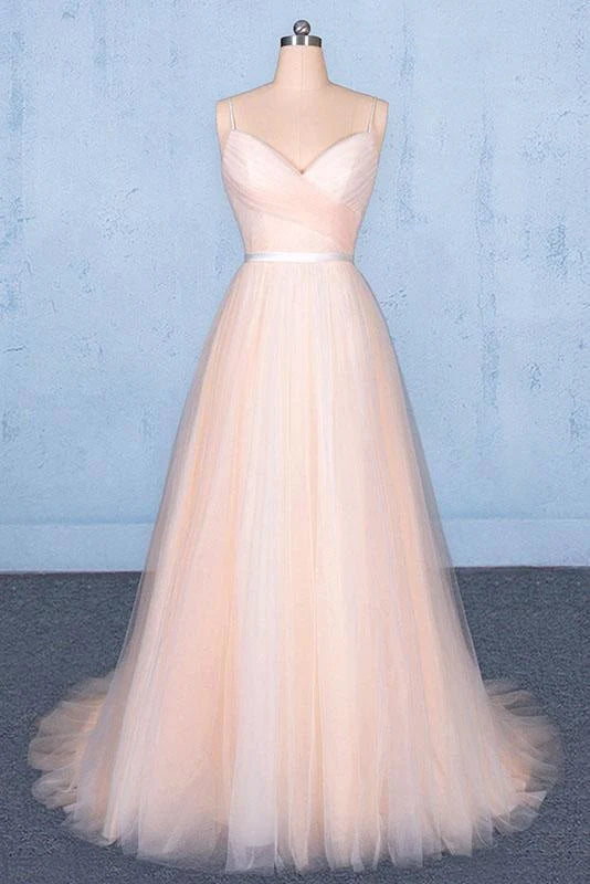 Model wearing an elegant A-line V-neck tulle prom dress with delicate straps.