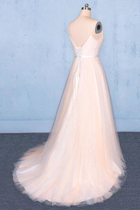 Close-up of the V-neckline and delicate straps on the tulle prom dress.