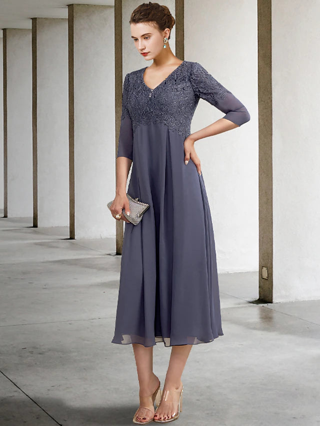 Close-up of the V-neckline, lace, and ruffled 3/4 sleeves on the elegant dress.
