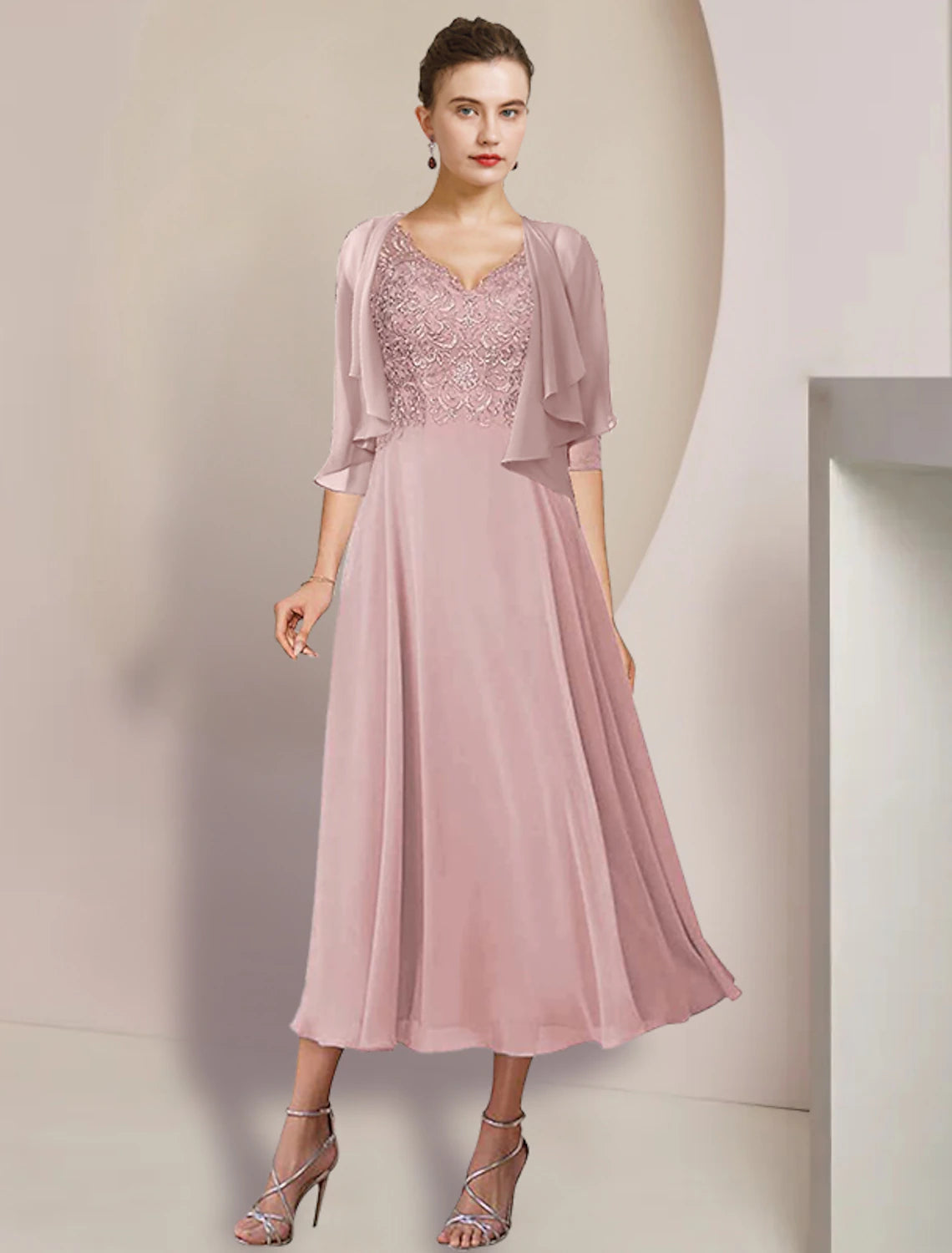 Elegant two-piece A-line V-neck tea length dress with 3/4 sleeves and lace appliques.