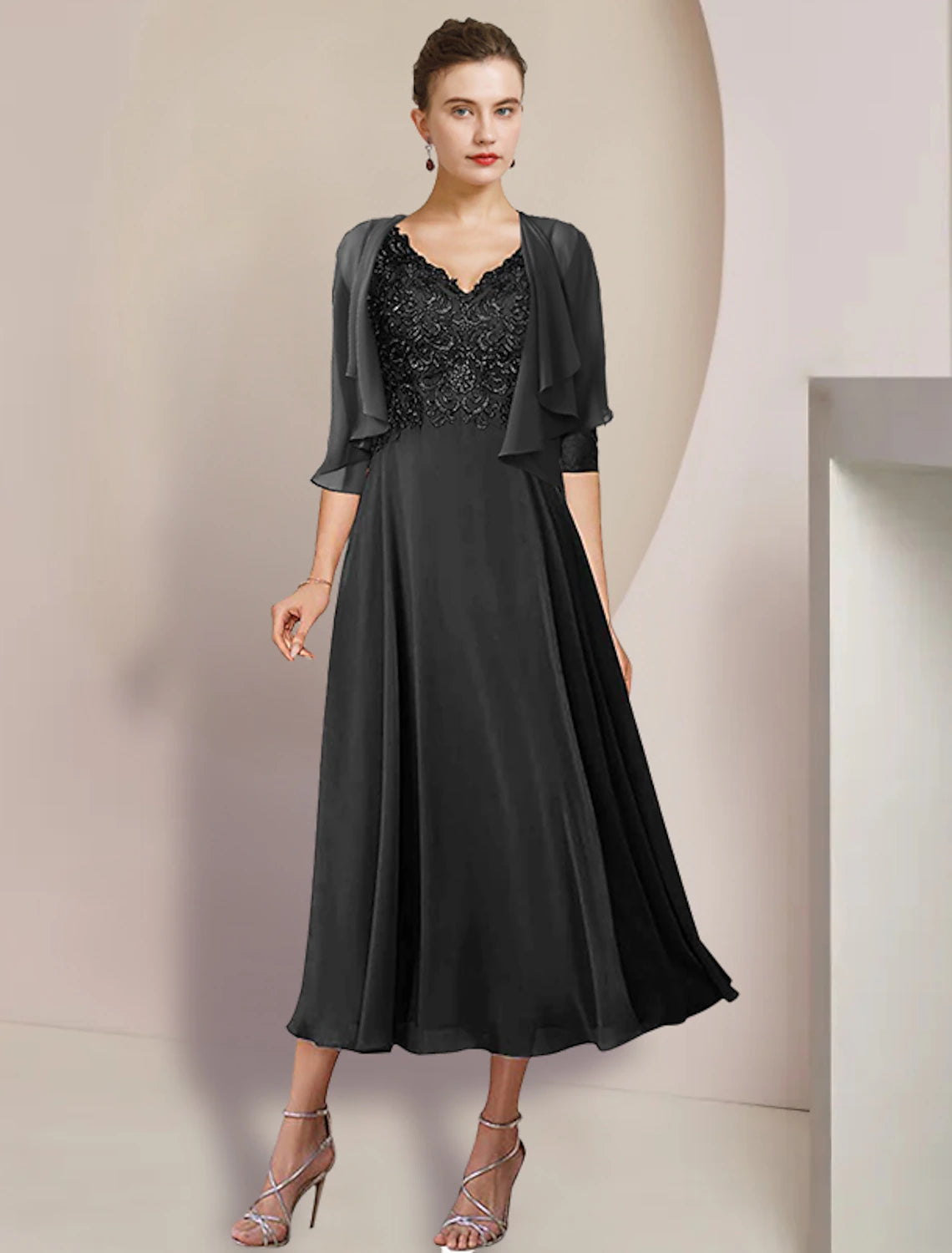 Close-up of the V-neckline and delicate lace appliques on the formal dress.