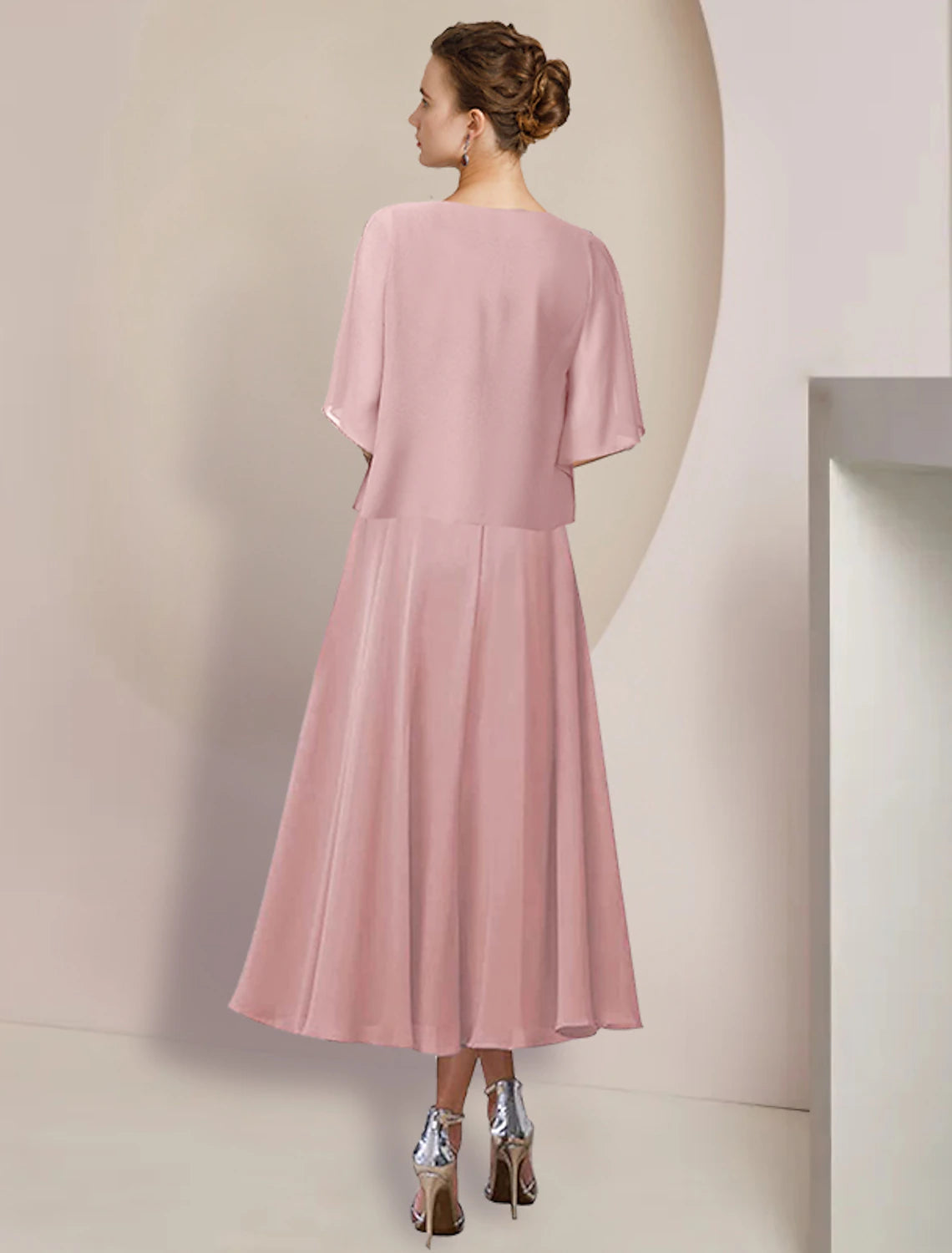 Side view of the A-line tea length dress, showing the flowing chiffon skirt.