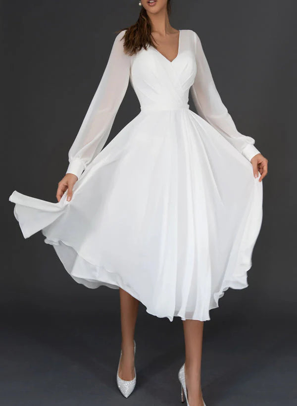 Model wearing an elegant A-line V-neck tea-length wedding dress, front view.