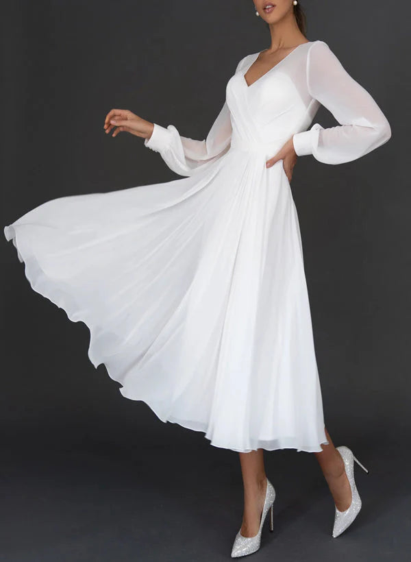 Back view of an A-line V-neck tea-length wedding dress on a model.