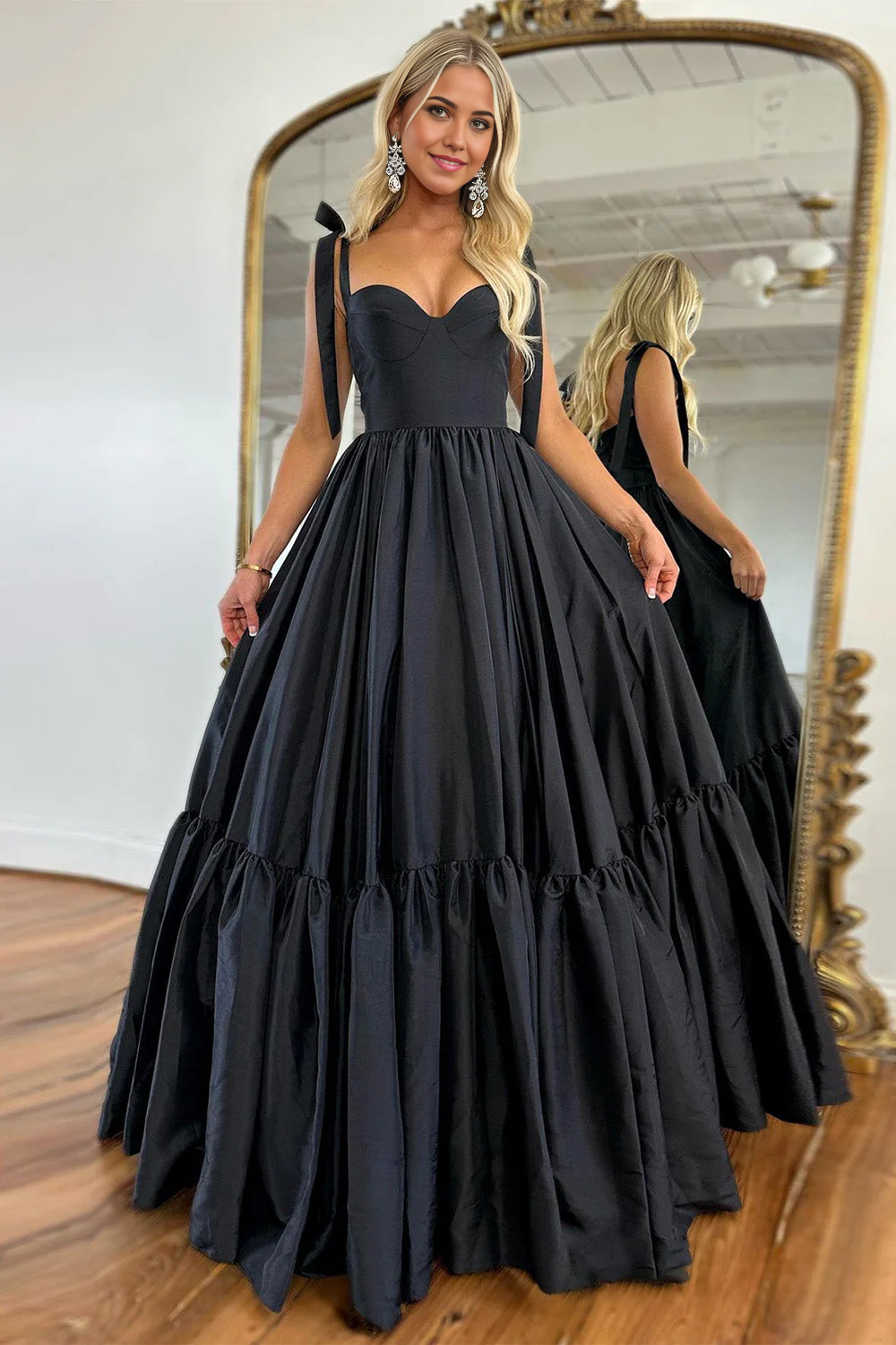 Long black evening gown with V-neck and flowing A-line skirt.