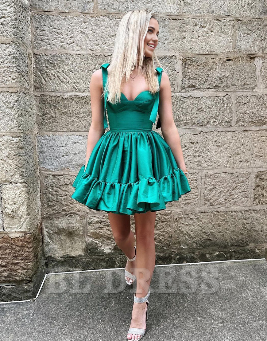 Close-up of the luxurious green satin fabric and tie-strap detail.