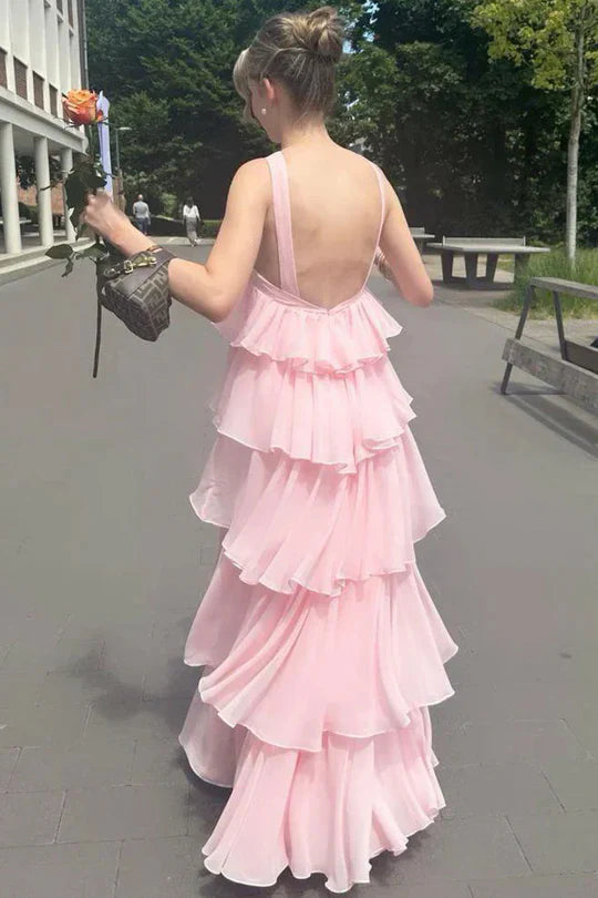 Side view of a pink A-line tiered chiffon bridesmaid dress.