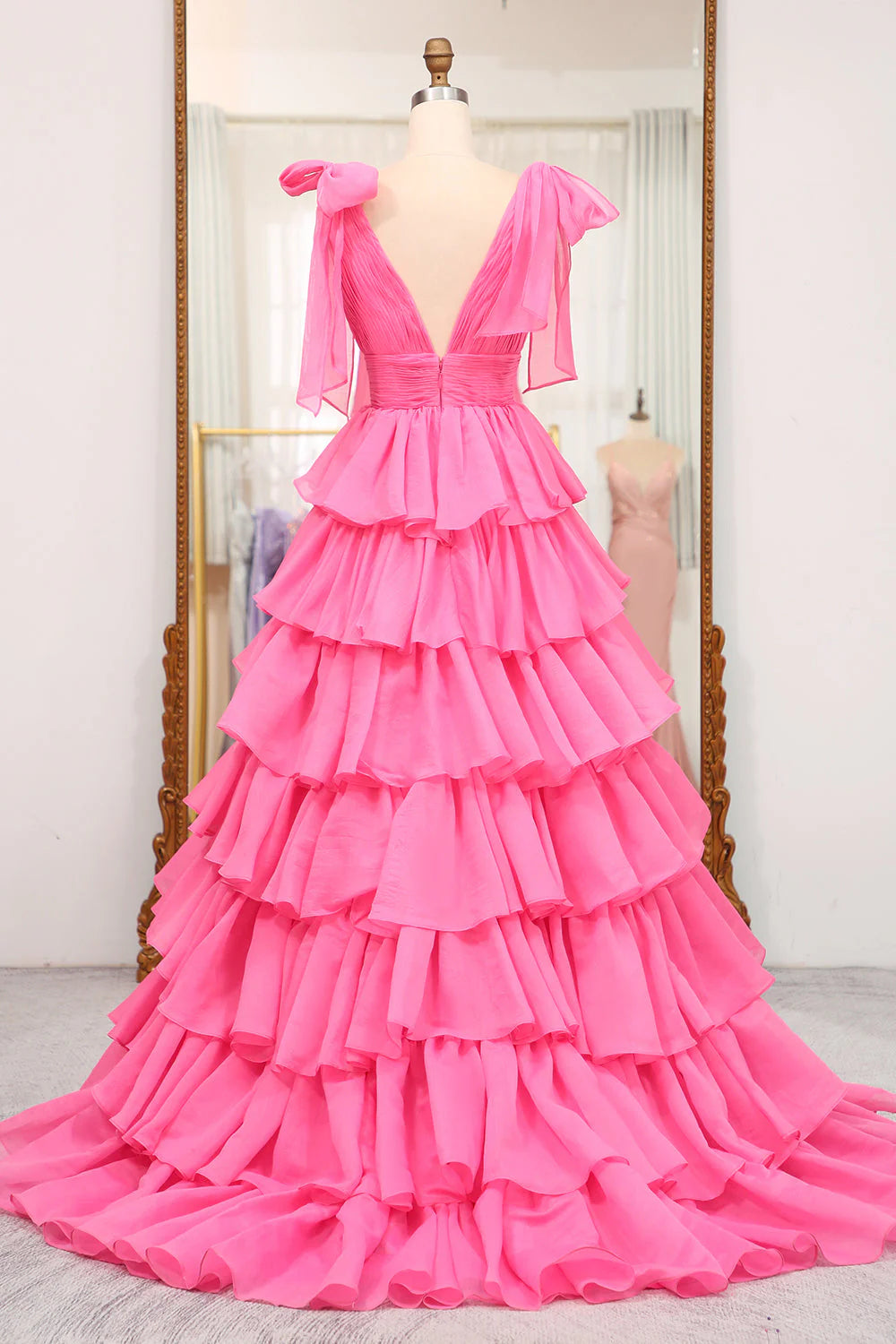Back view of an A-line V-neck tiered long formal dress, showcasing the flowing skirt.