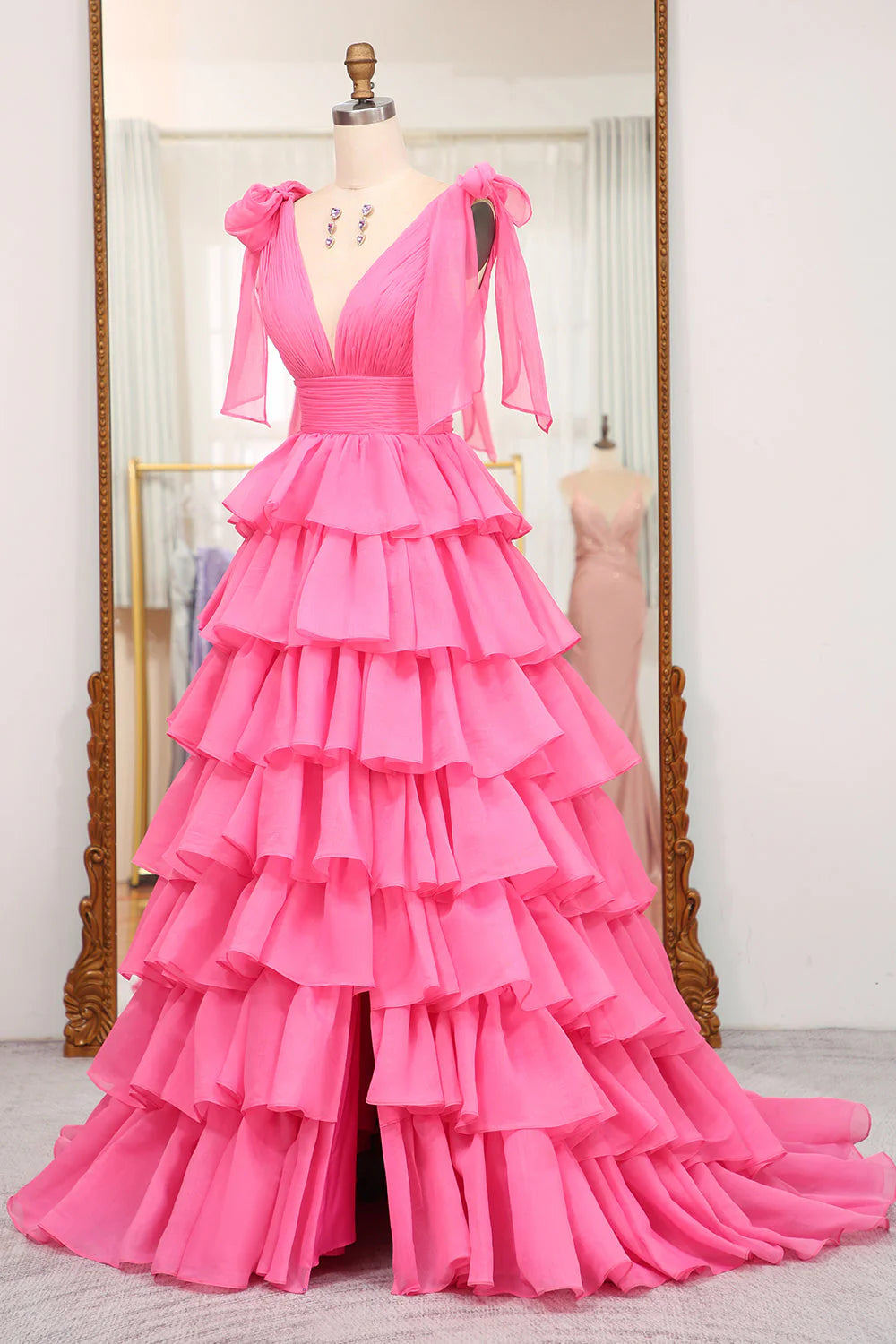 Side view of an A-line V-neck tiered long gown with a slit, highlighting the silhouette.